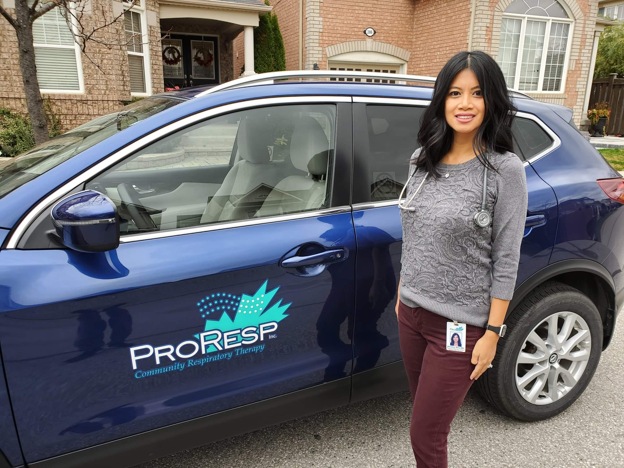 ProResp Female Employee beside vehicle
